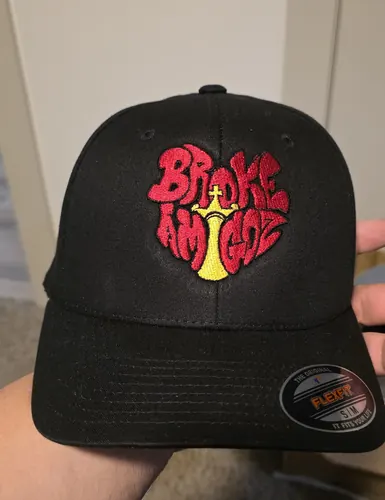 Black Flexfit cap with a red and yellow Broke Amigoz logo