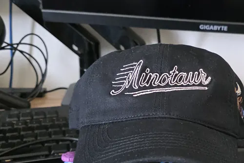 Black dad hat with a white Minotaur script logo